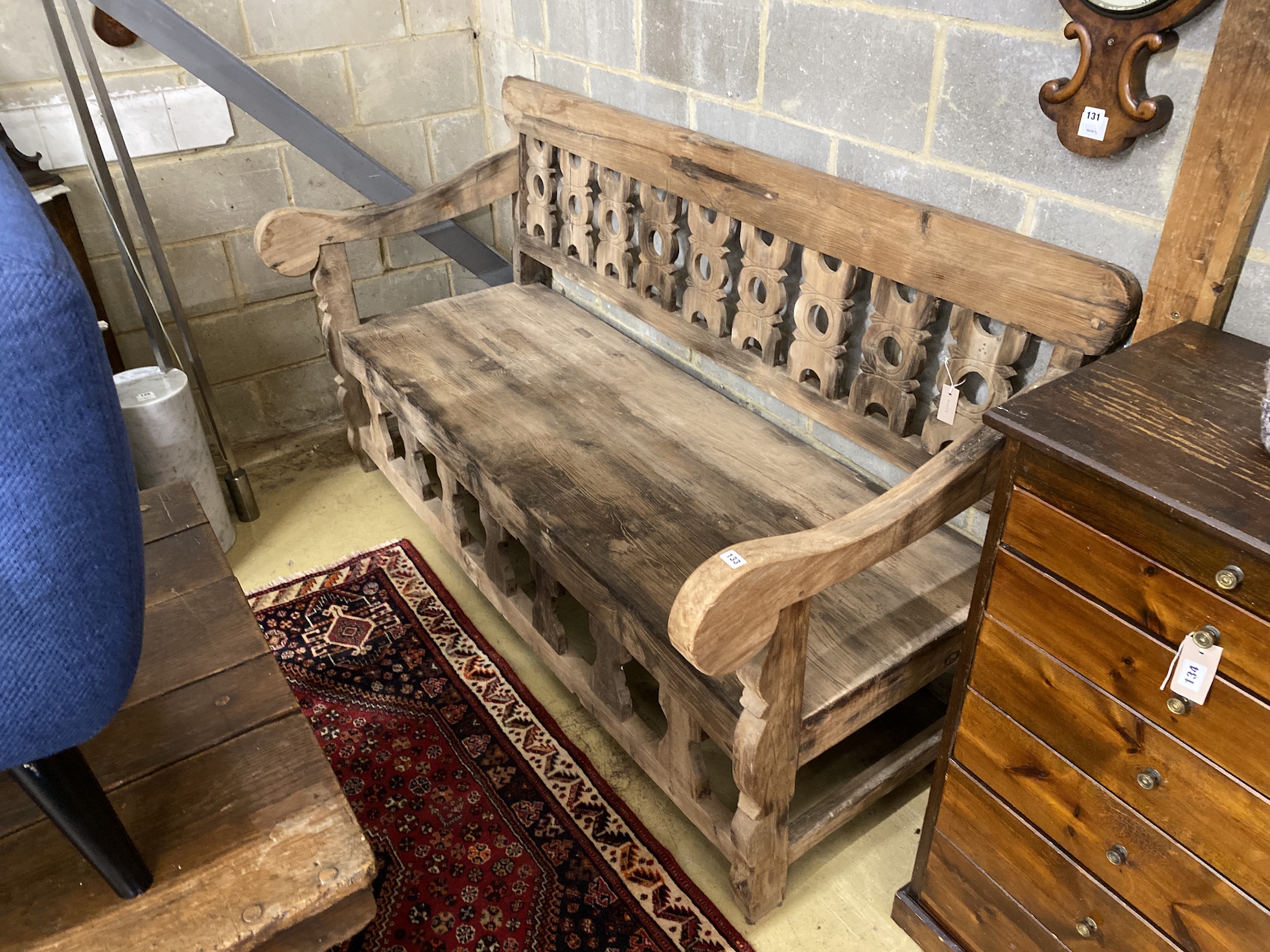 A carved hardwood settle from reclaimed boat timbers, length 191cm, depth 83cm, height 107cm